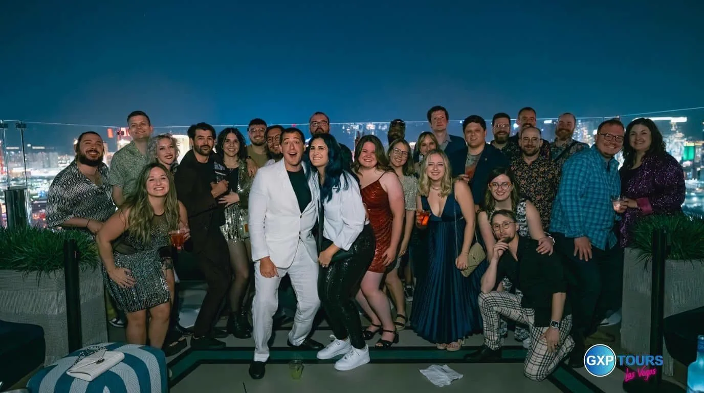 A large group on a night out at a Las Vegas nightclub with the Strip behind them