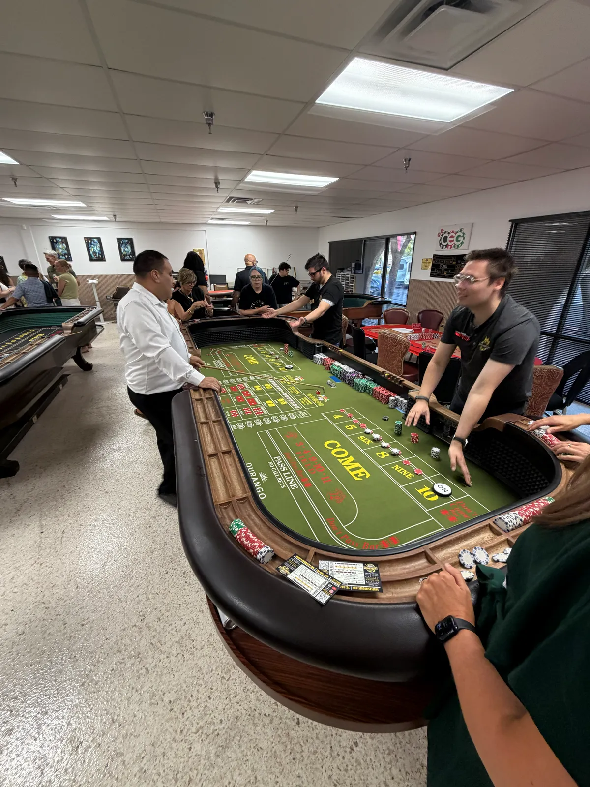 Instructors and guests around a real craps table during a Las Vegas lesson