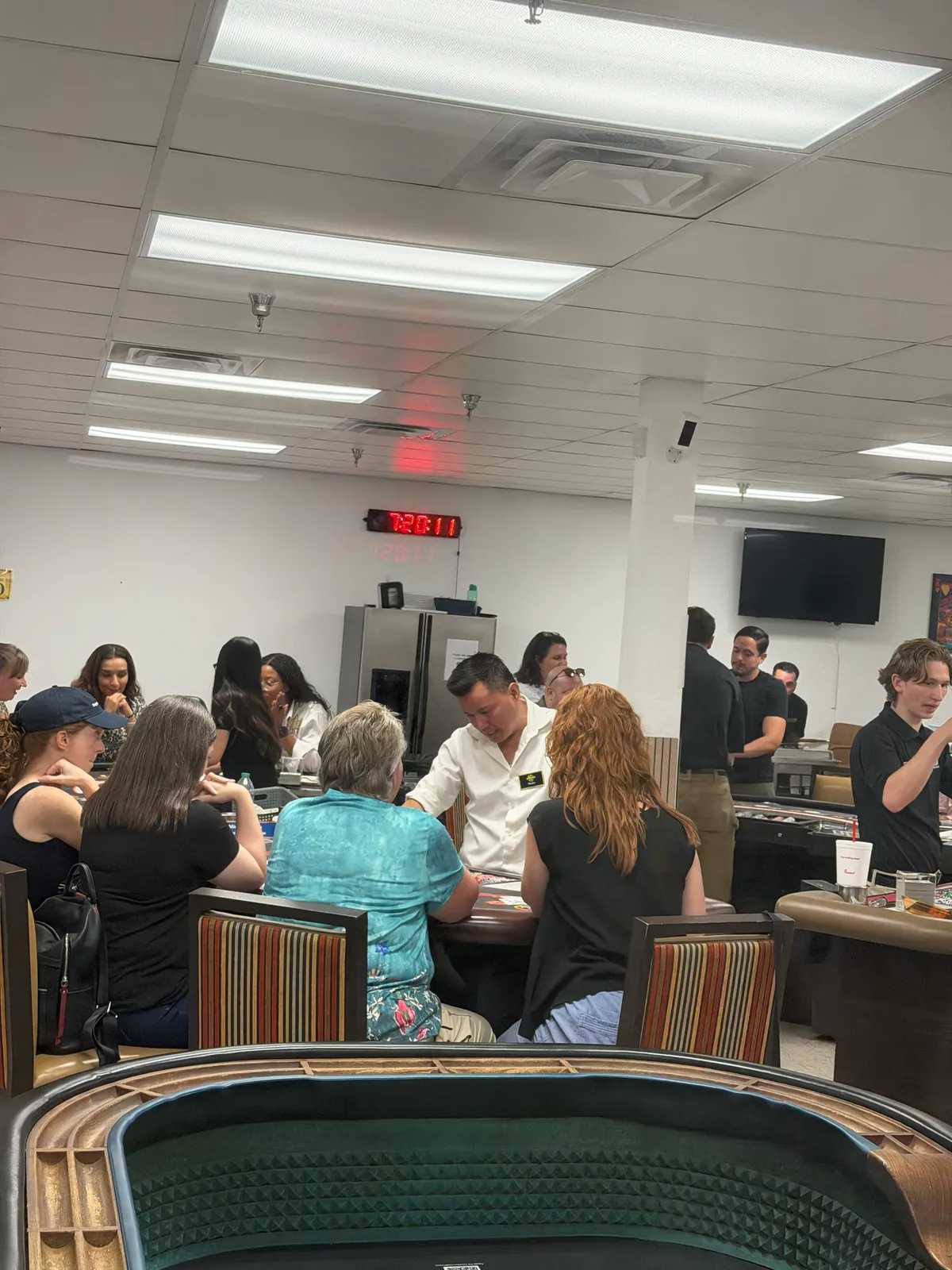 A dealer giving focused instruction to one table group during a private Las Vegas lesson