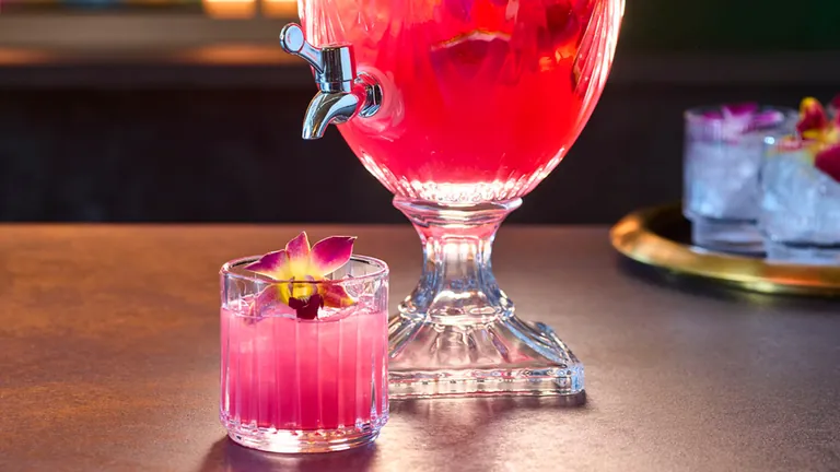 Shared sparkling punch service in a footed glass dispenser at Vinyl Room Las Vegas